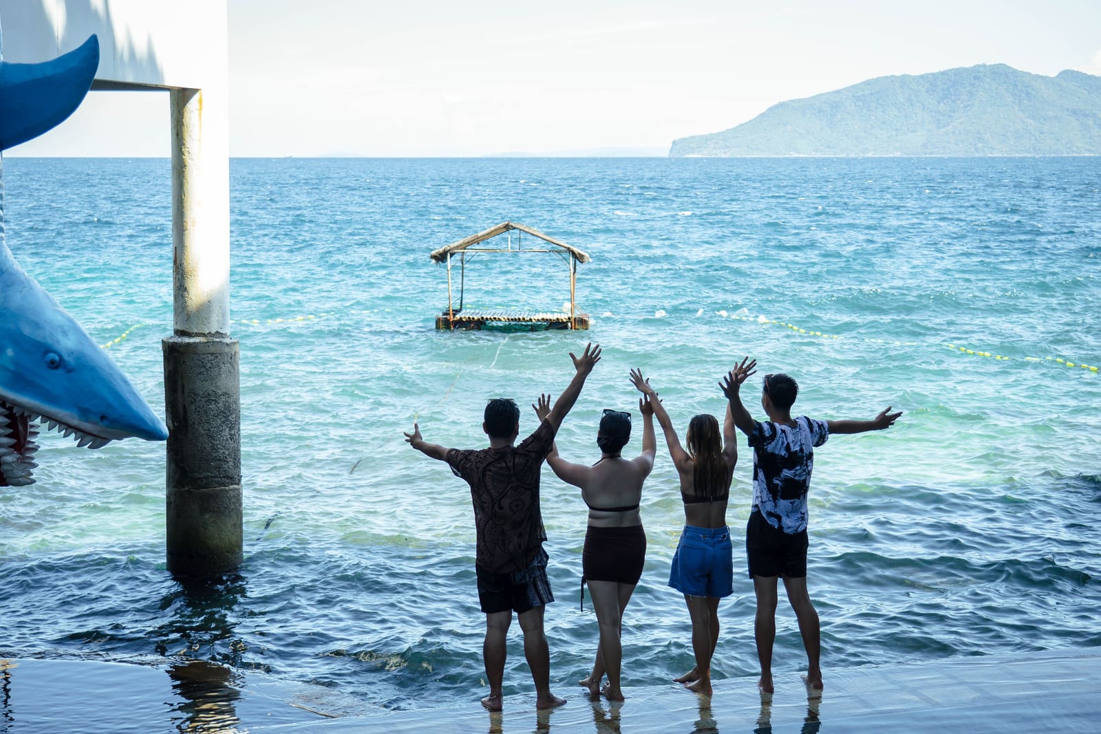 Friends at the water’s edge facing the sea at Isola Vista Beach Resort, Pagkilatan